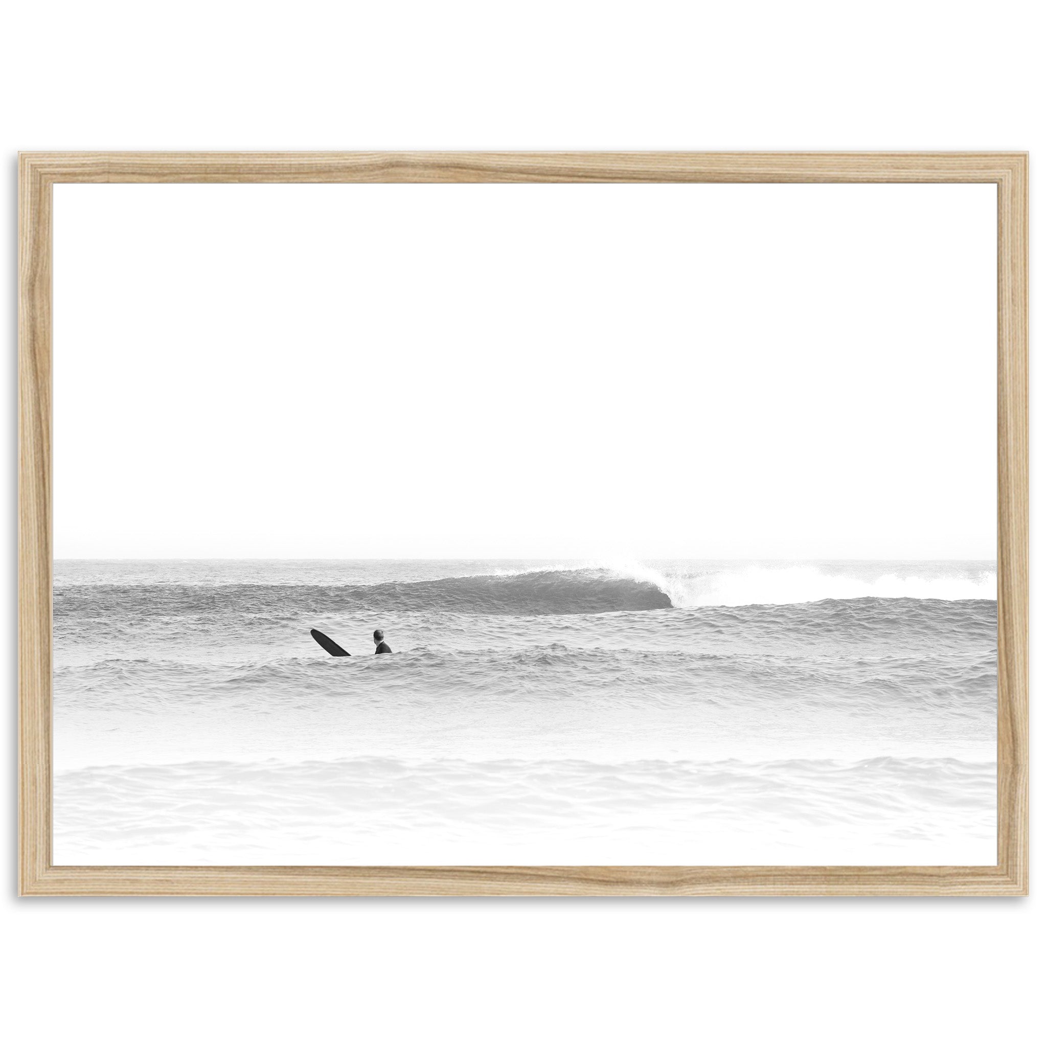 a black and white photo of a surfer riding a wave