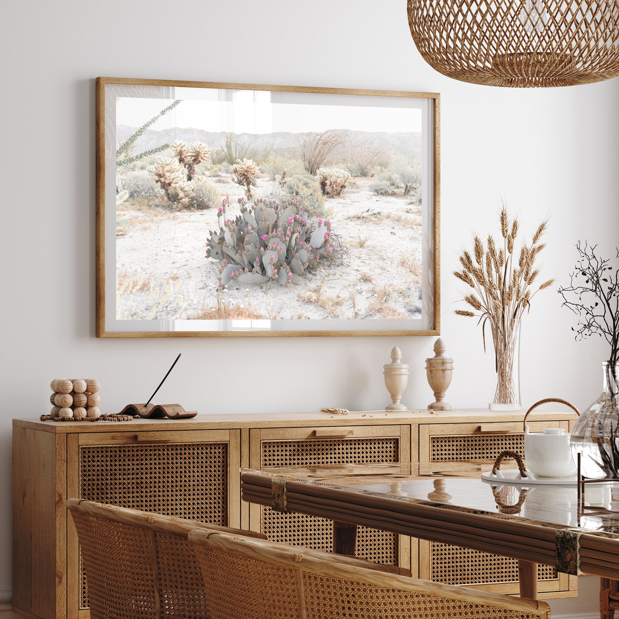 a picture of a desert scene hangs above a dining room table