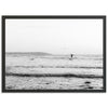 a black and white photo of a person on a surfboard in the ocean