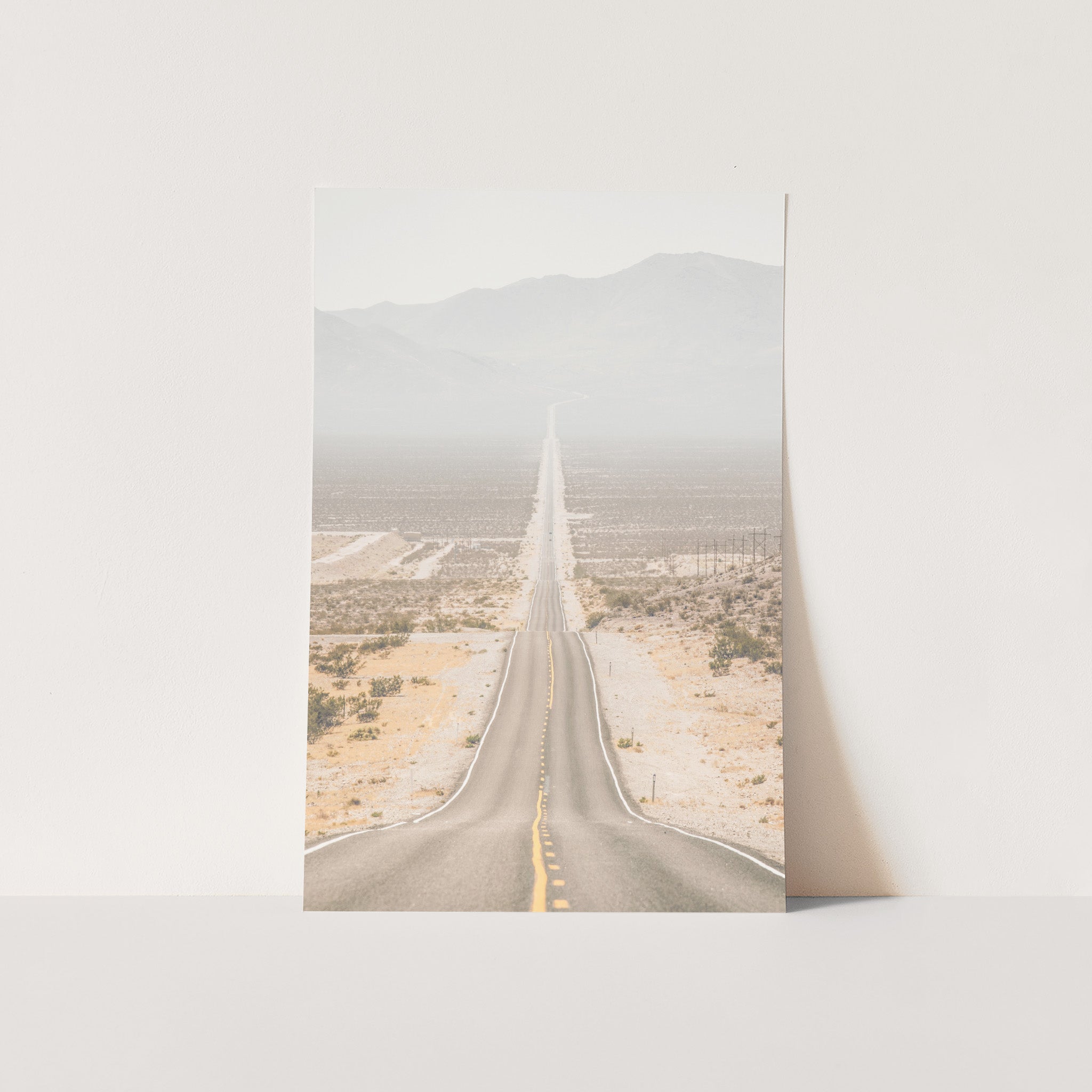 a photograph of an empty road in the desert