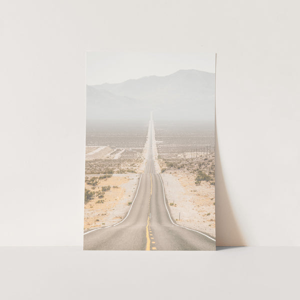 a photograph of an empty road in the desert