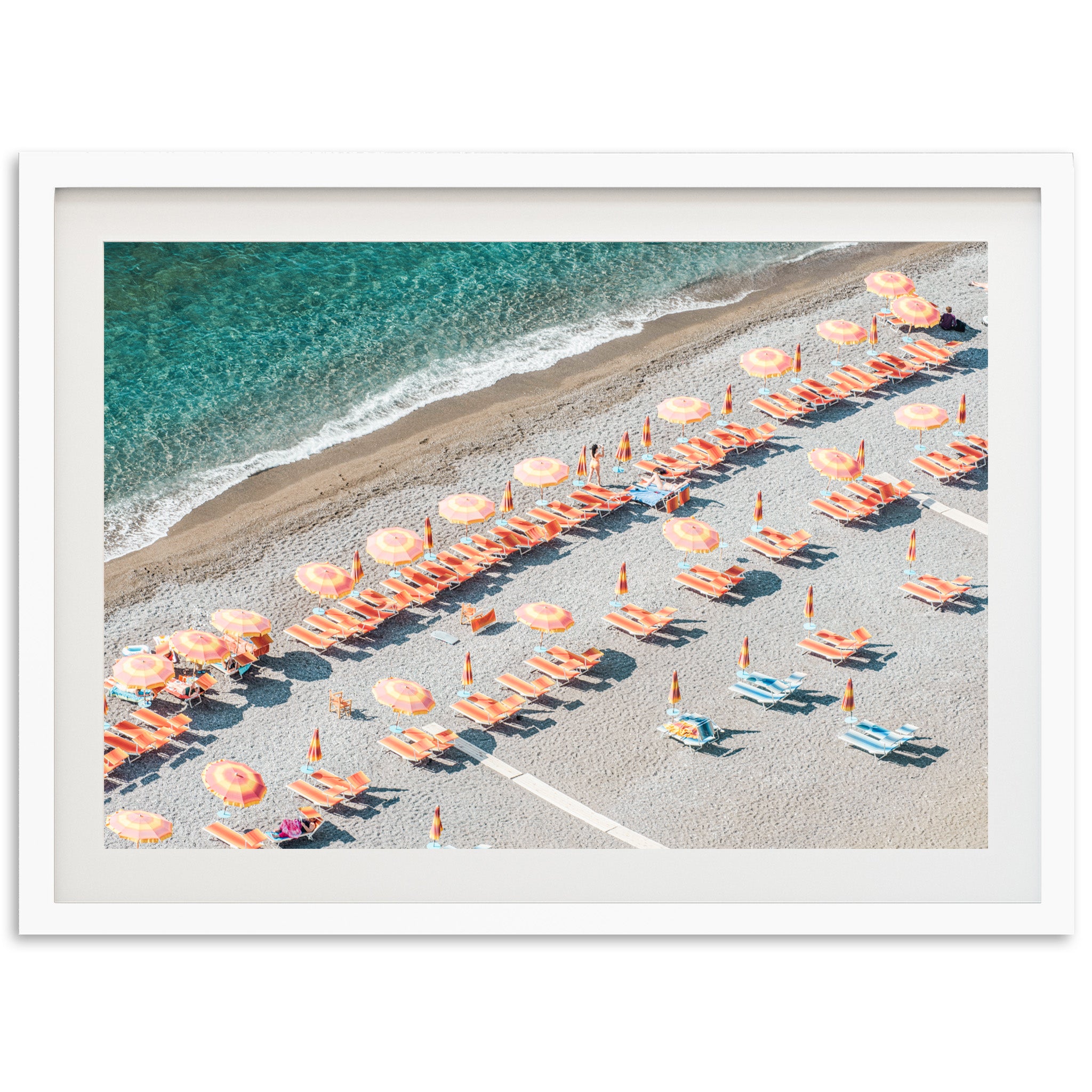 an aerial view of a beach with umbrellas and chairs