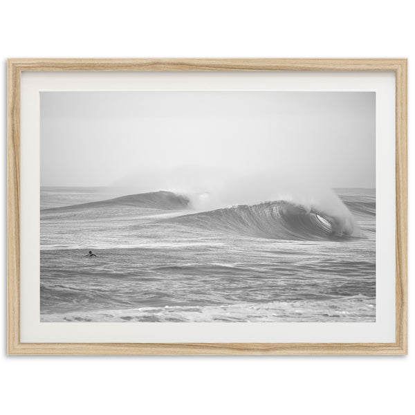 a black and white photo of a surfer riding a wave