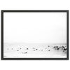 a black and white photo of surfers in the ocean