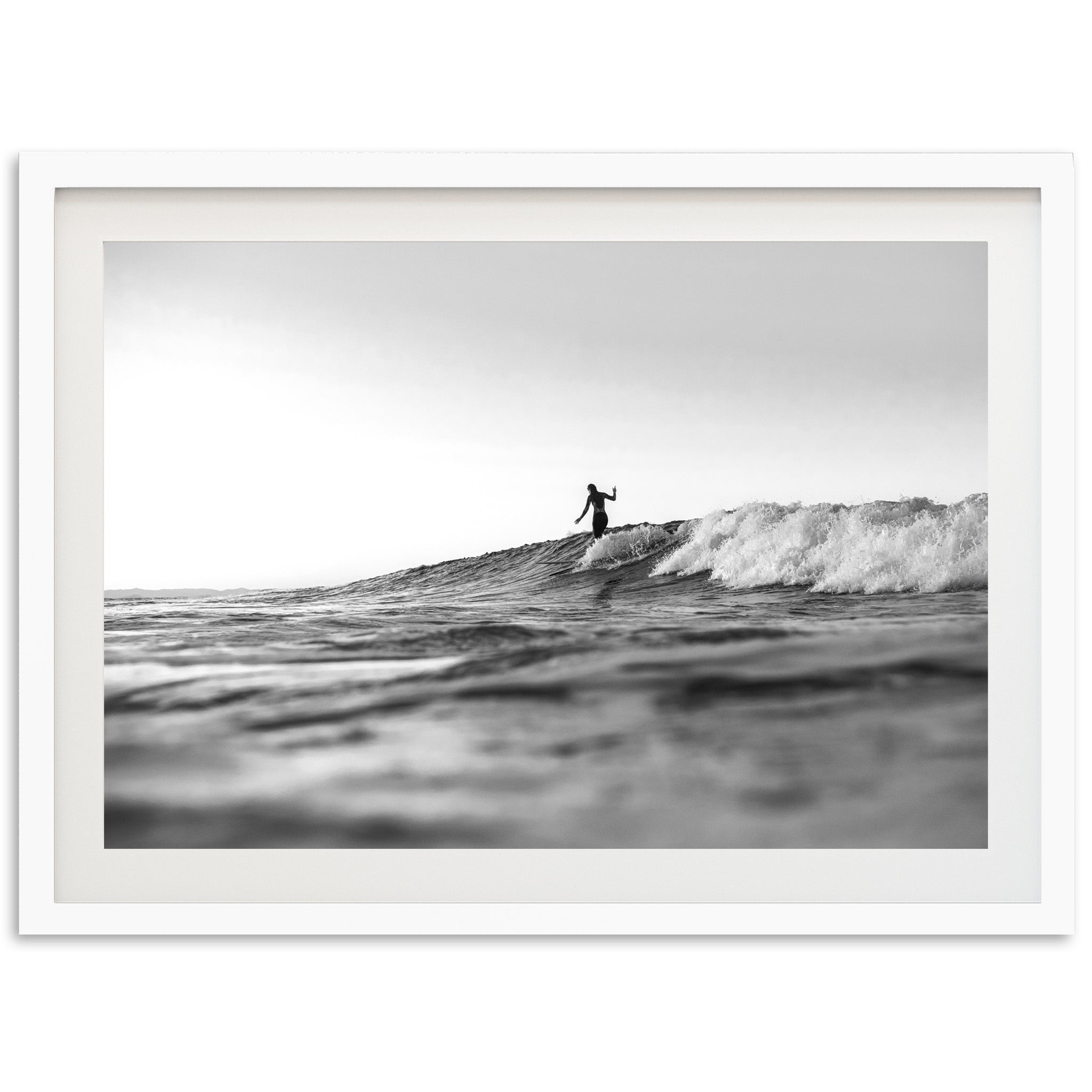 a man riding a wave on top of a surfboard