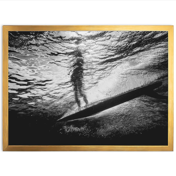 a black and white photo of a person on a surfboard