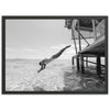 a black and white photo of a person diving into the water