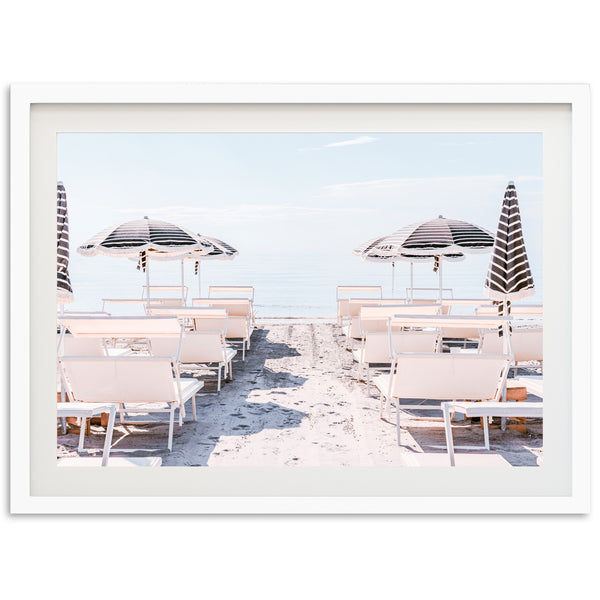 a picture of some chairs and umbrellas on the beach