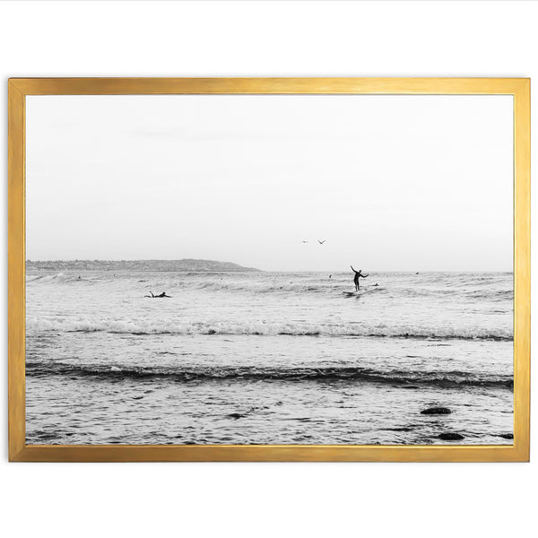 a black and white photo of a person surfing in the ocean