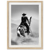 a black and white photo of a cowboy on a horse