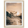 a picture of a wave in the ocean with palm trees in the background