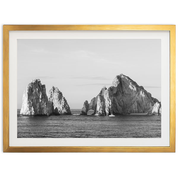 a black and white photo of rocks in the ocean