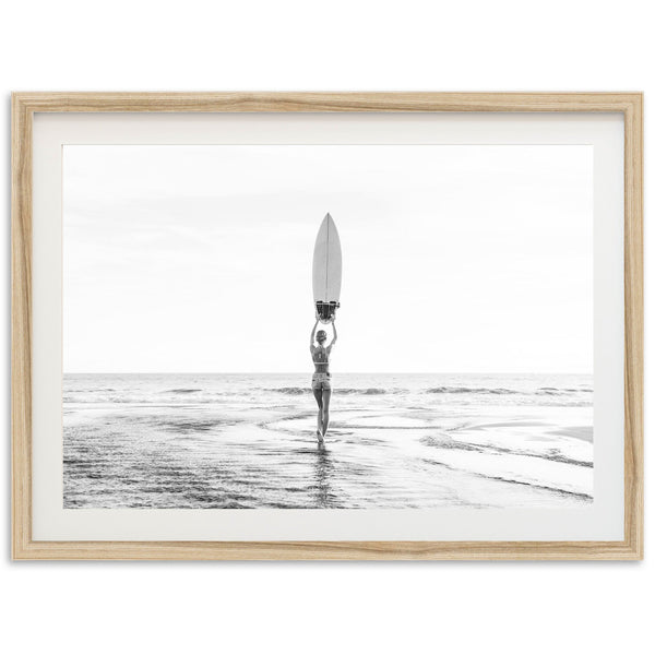 a person holding a surfboard standing in the ocean