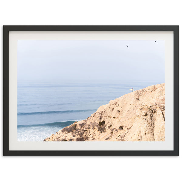 a picture of a person standing on a cliff overlooking the ocean