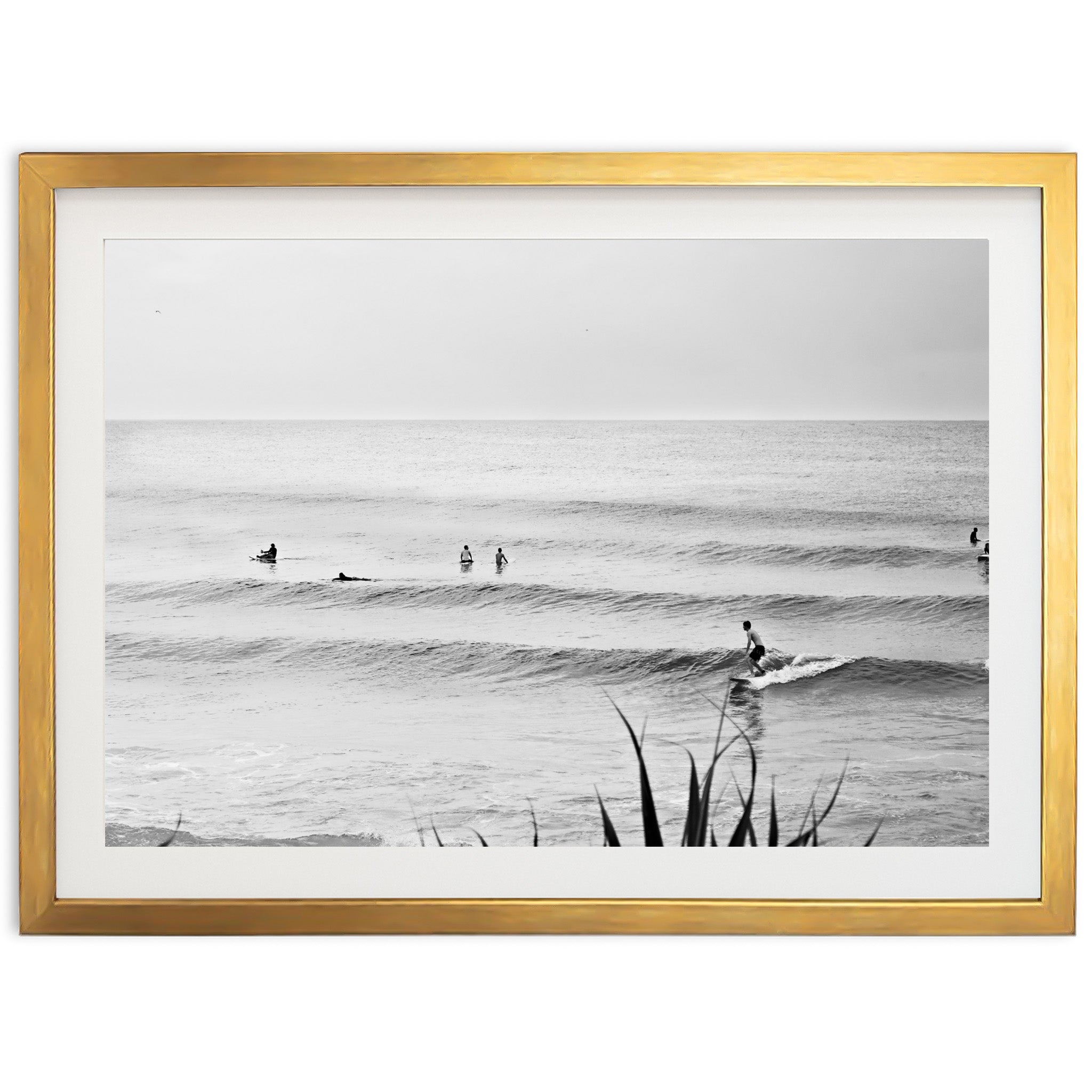 a black and white photo of surfers in the ocean