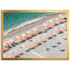 an aerial view of a beach with umbrellas and chairs