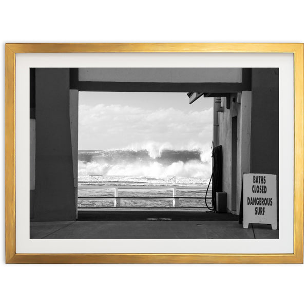 a black and white photo of a wave coming in from the ocean