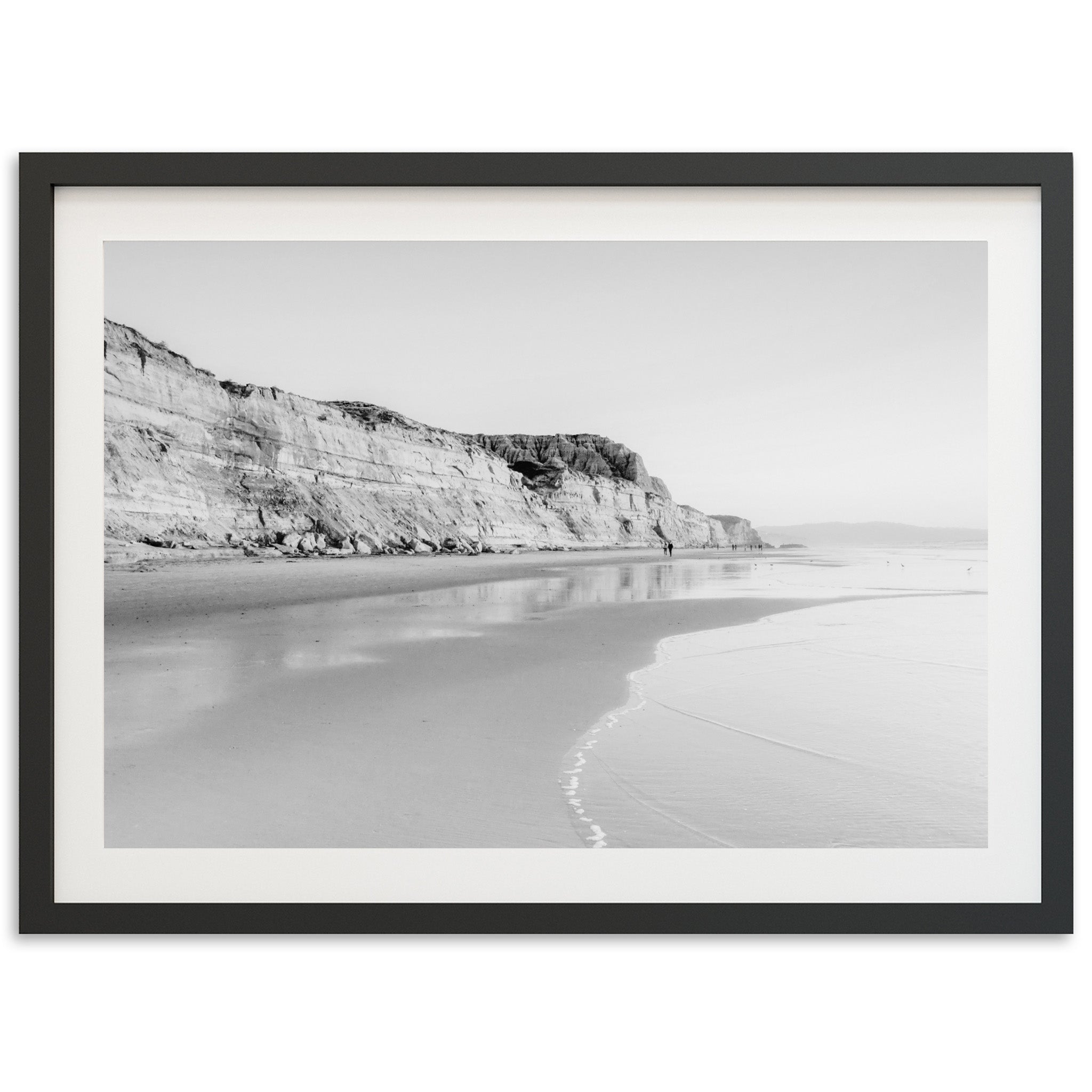 a black and white photo of a beach