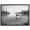 a black and white photo of a person diving into a lake