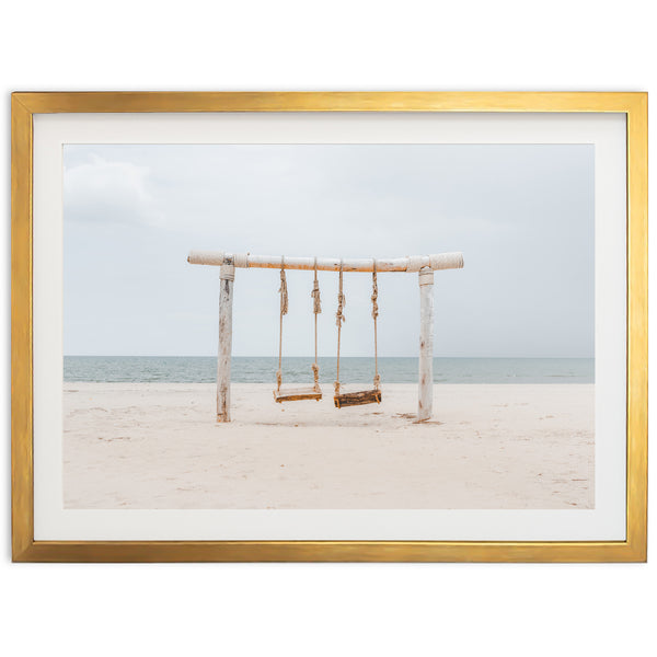 a picture of a swing set on a beach