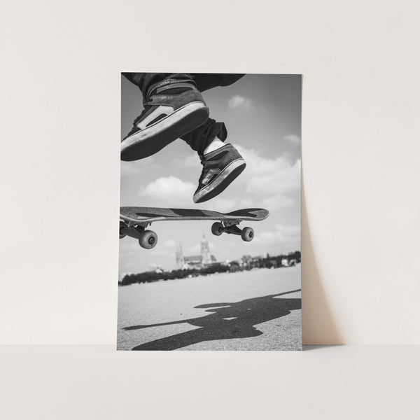 a black and white photo of a person jumping a skateboard