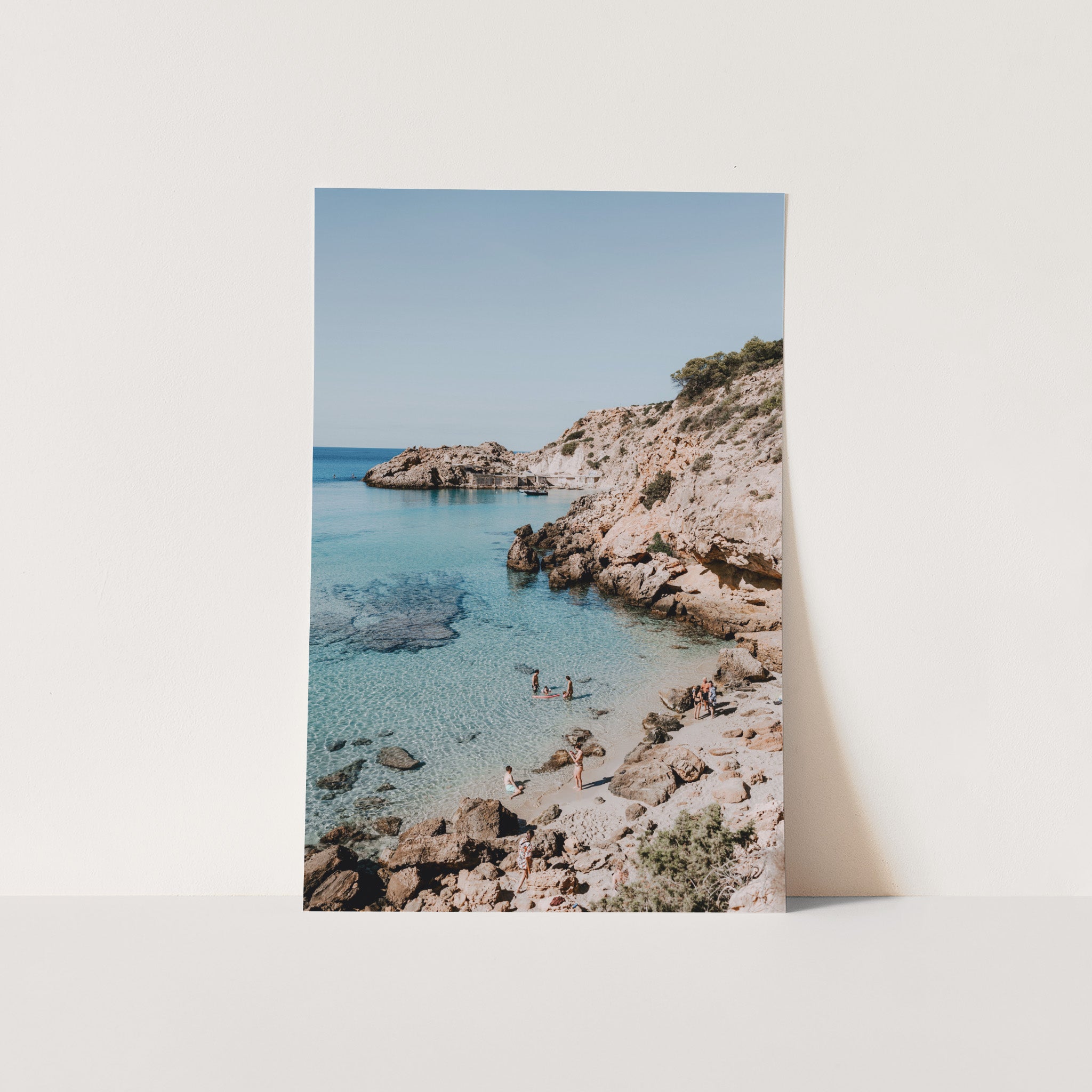 a picture of a beach with people in the water