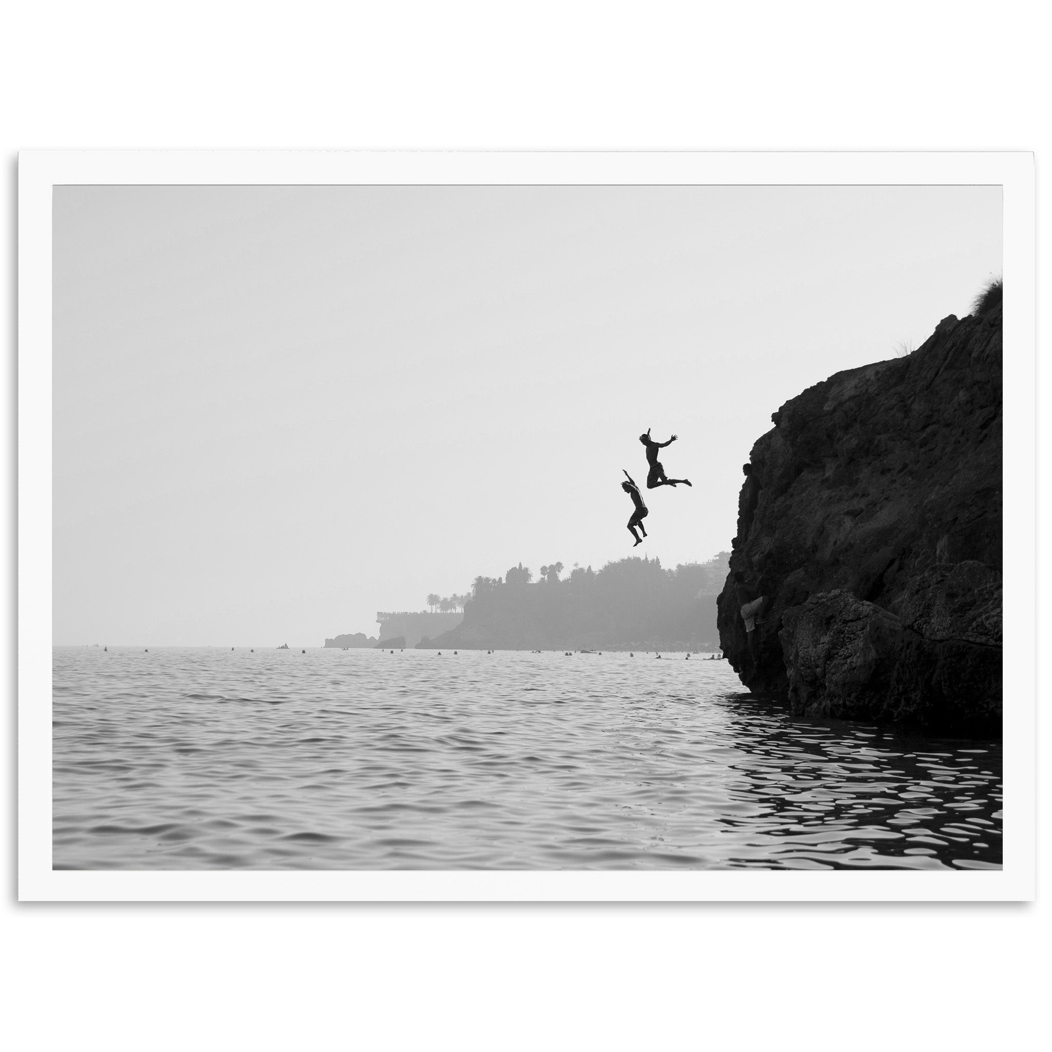 a person jumping off a cliff into the water