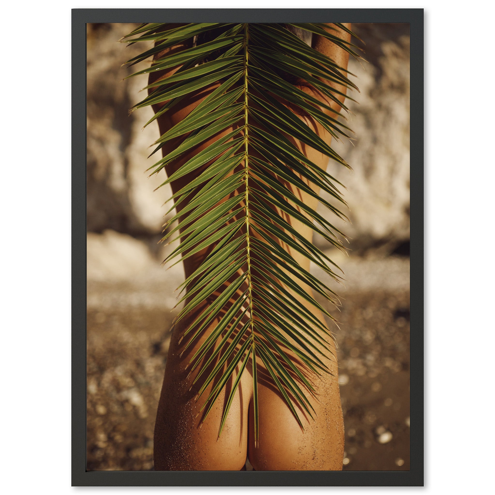 a picture of a woman's butt with a palm leaf