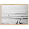 a black and white photo of people surfing in the ocean