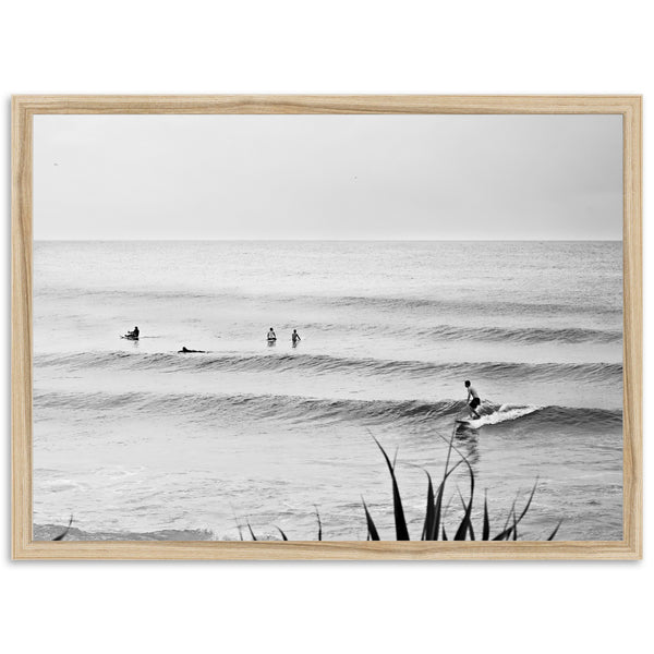 a black and white photo of people surfing in the ocean