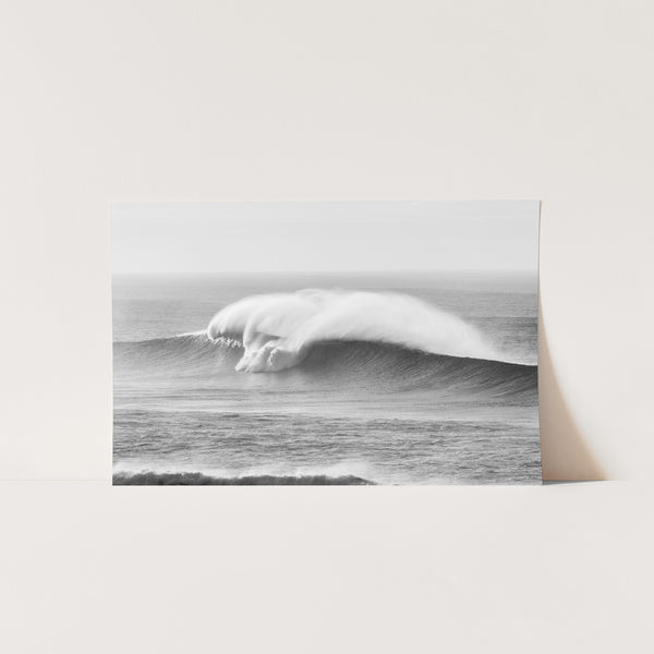 a black and white photo of a large wave