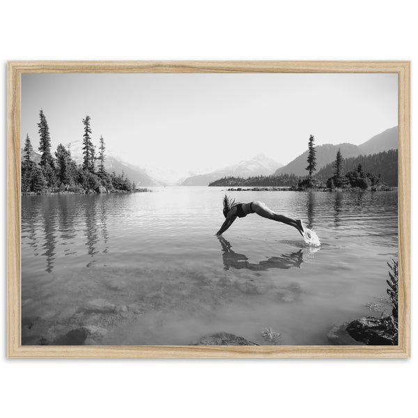 a black and white photo of a person doing a handstand in the water