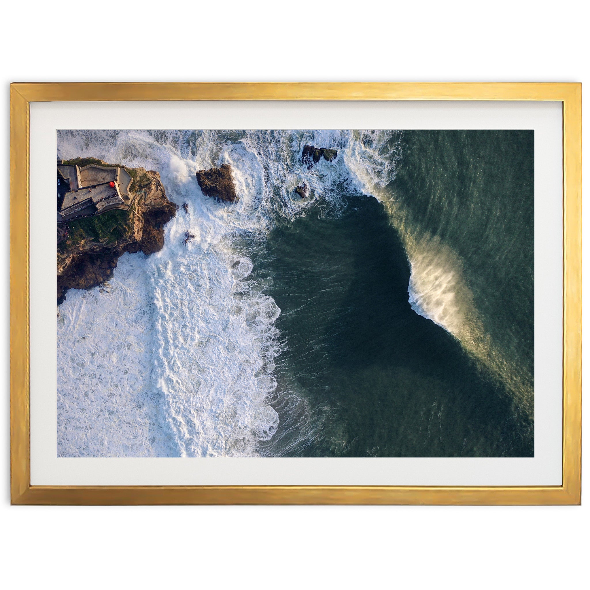 an aerial view of the ocean with a house in the distance