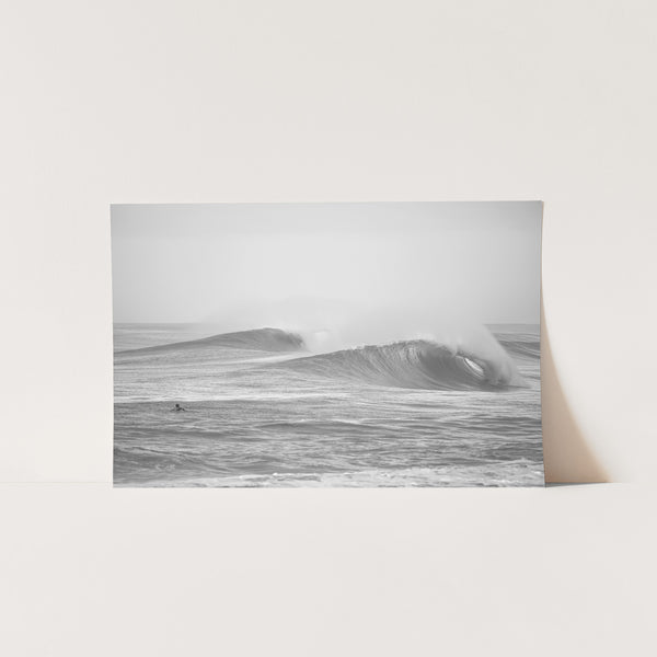 a black and white photo of a wave in the ocean