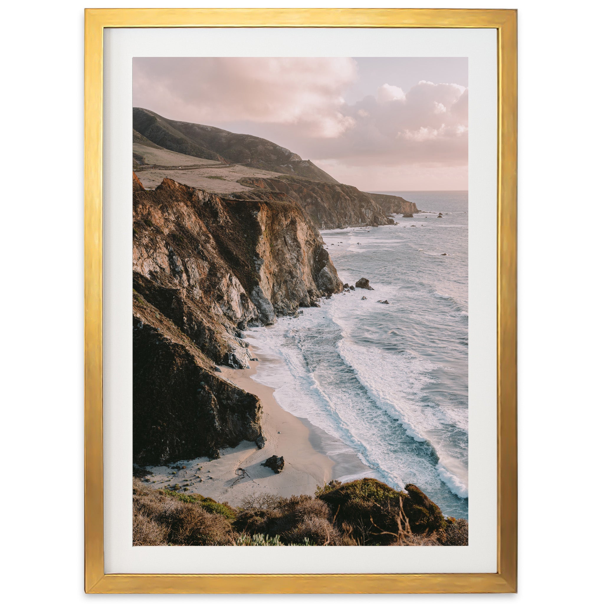 a picture of a beach with a cliff in the background