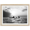 a black and white photo of two people on surfboards