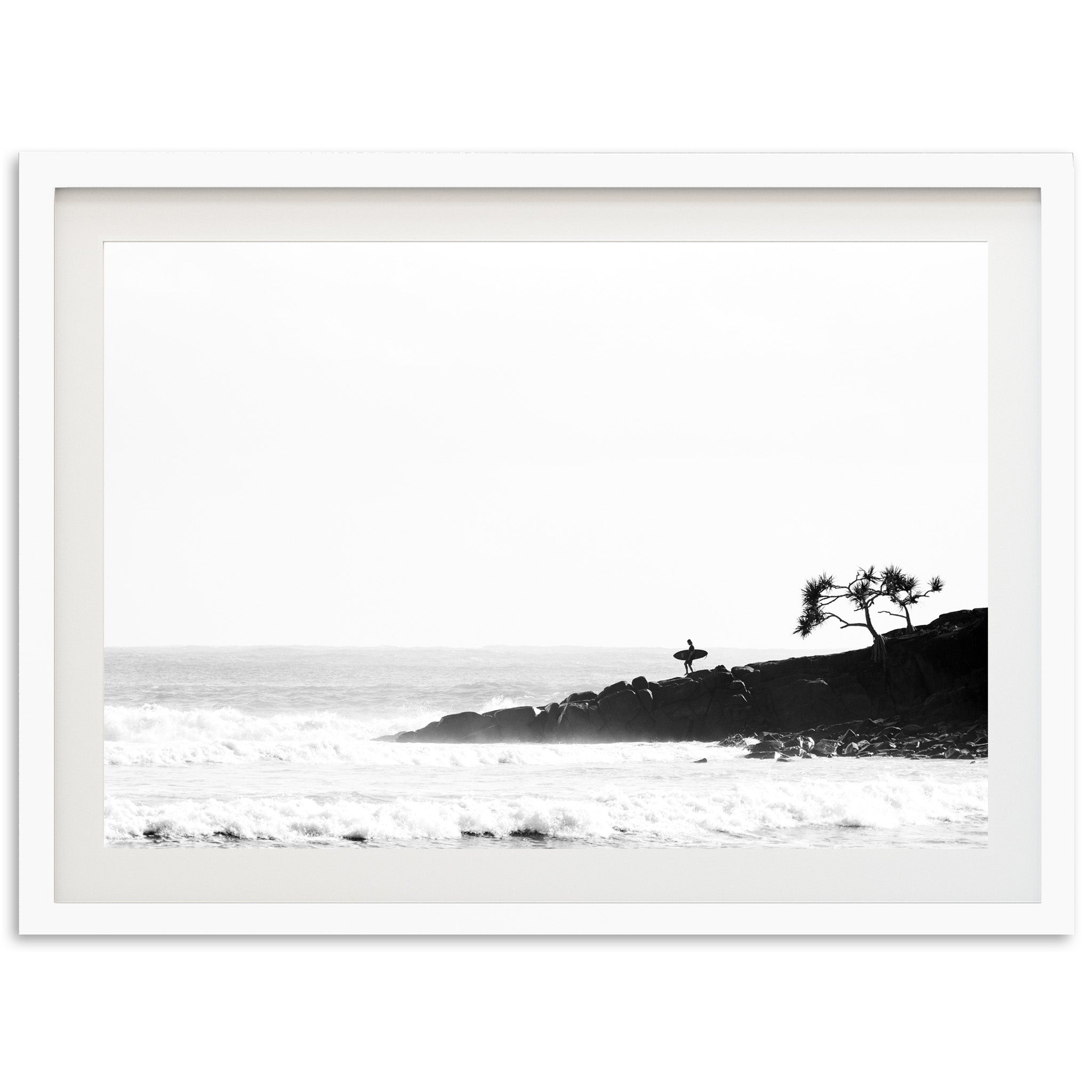 a black and white photo of a beach with waves