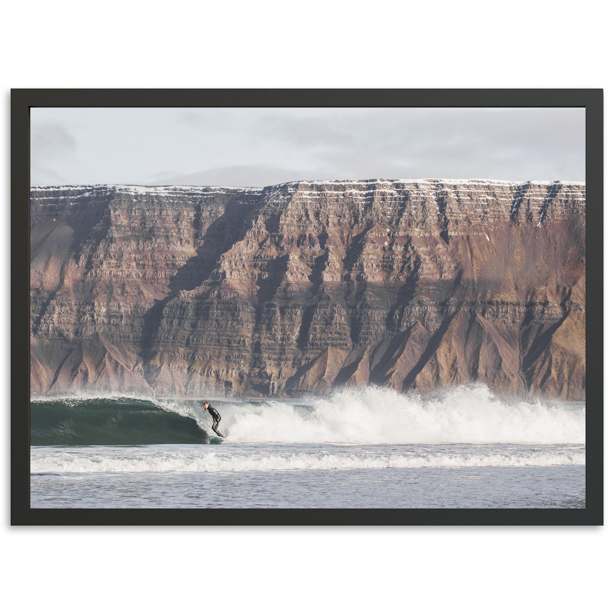 a man riding a wave on top of a surfboard