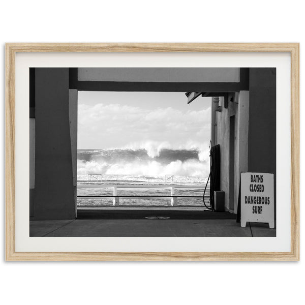 a black and white photo of a wave coming in from the ocean