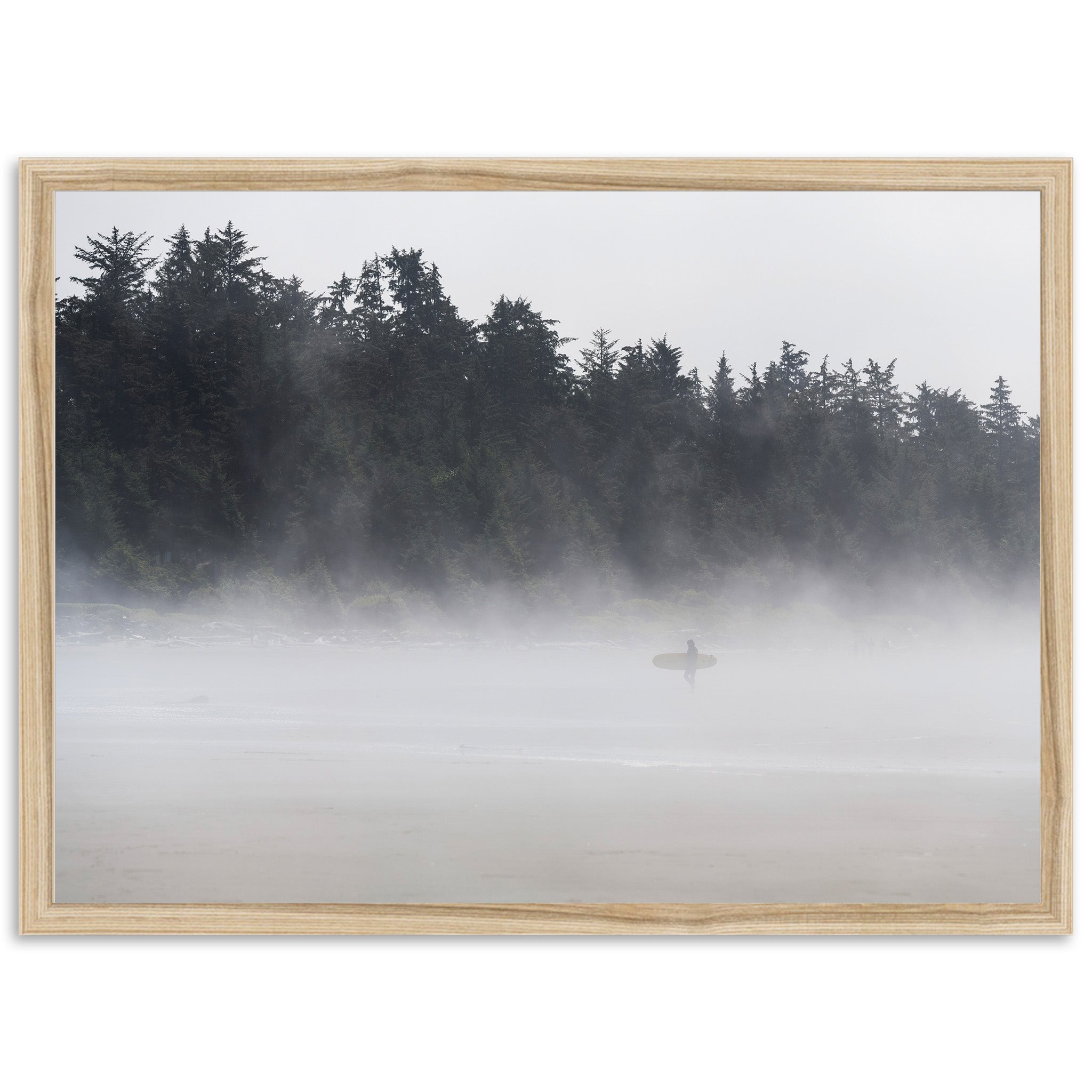 a person with a surfboard on a foggy beach