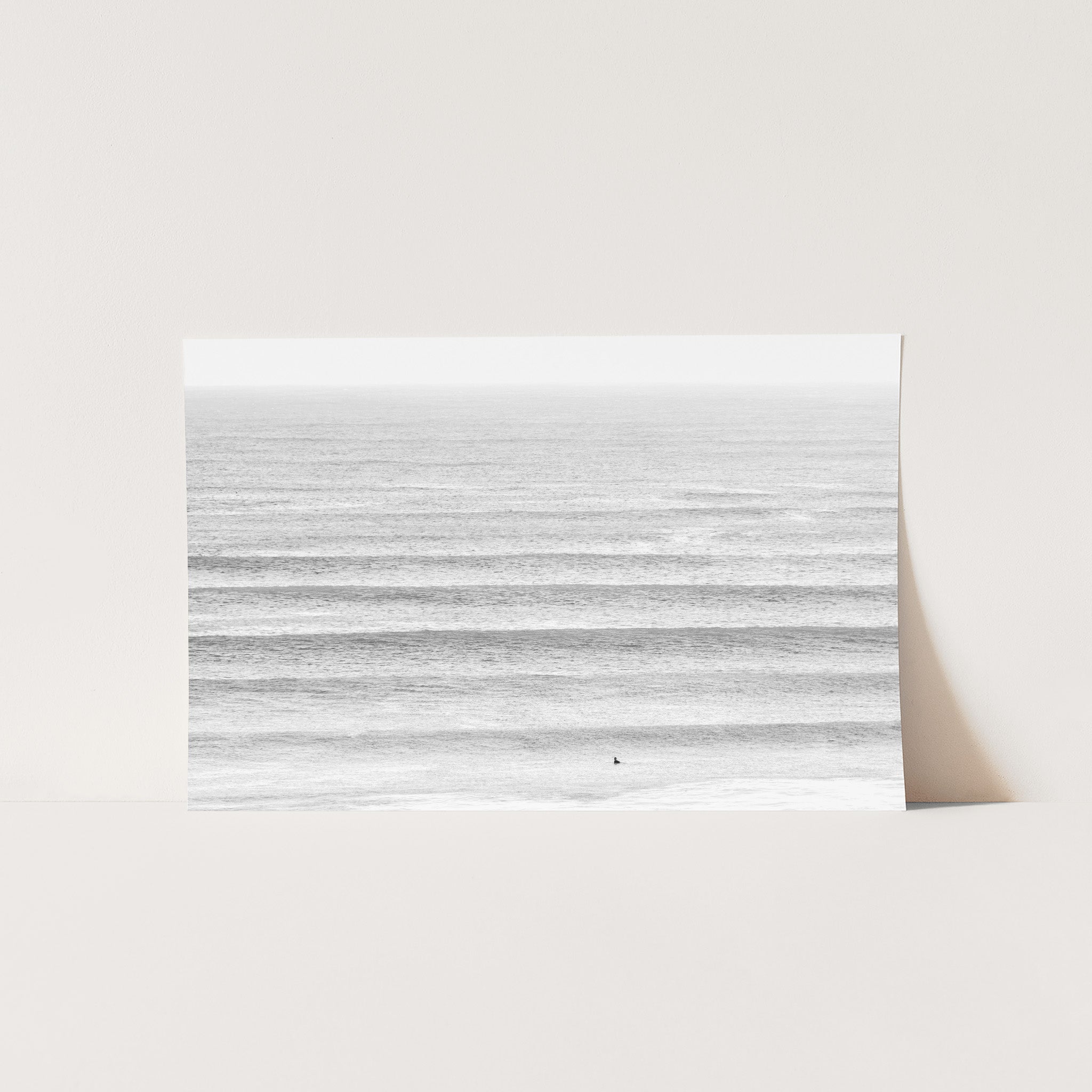 a white photo of a beach with waves