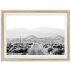 a black and white photo of a road in the desert