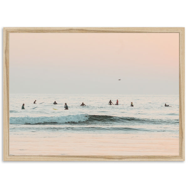 a group of people riding surfboards on top of a wave