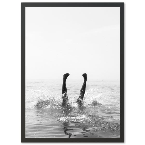 a black and white photo of a person in the water