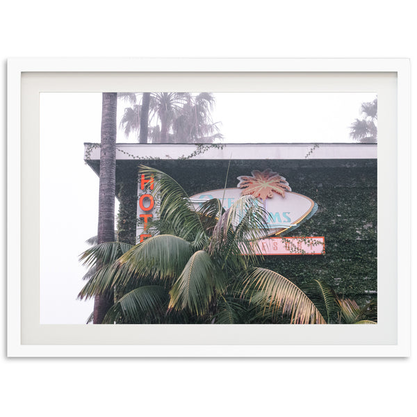 a picture of a neon sign and palm trees