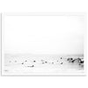 a black and white photo of surfers in the ocean