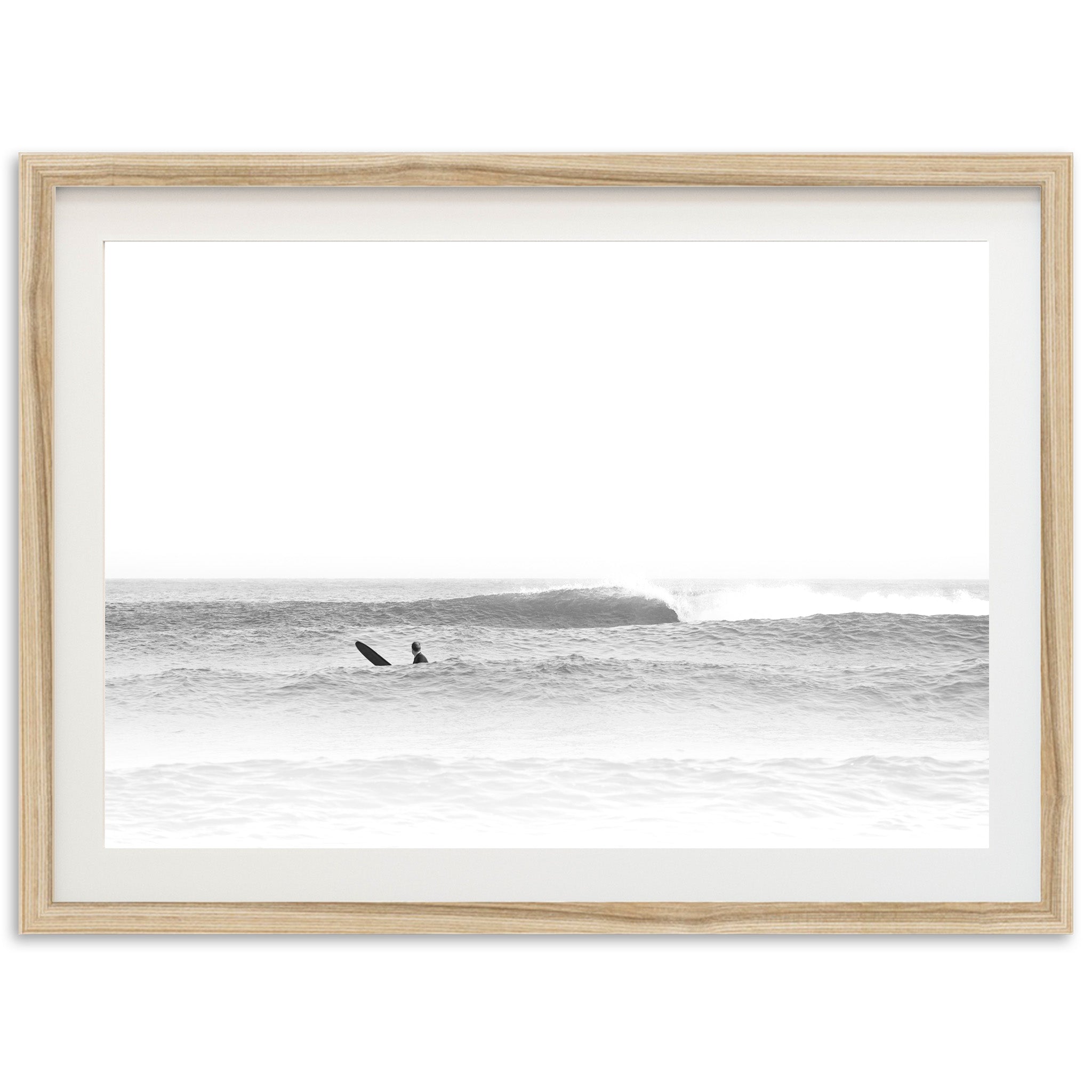 a black and white photo of a surfer riding a wave