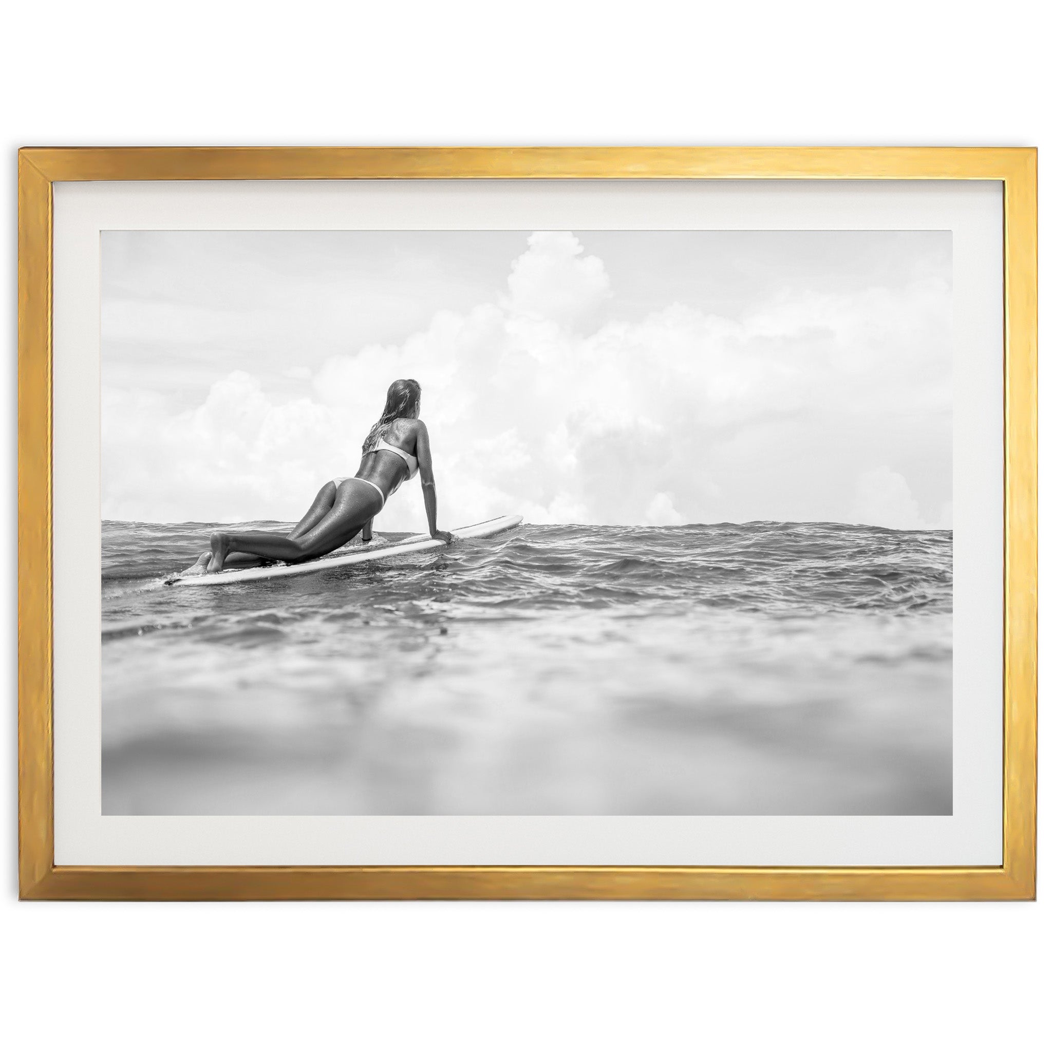 a woman laying on a surfboard in the ocean