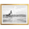 a woman laying on a surfboard in the ocean