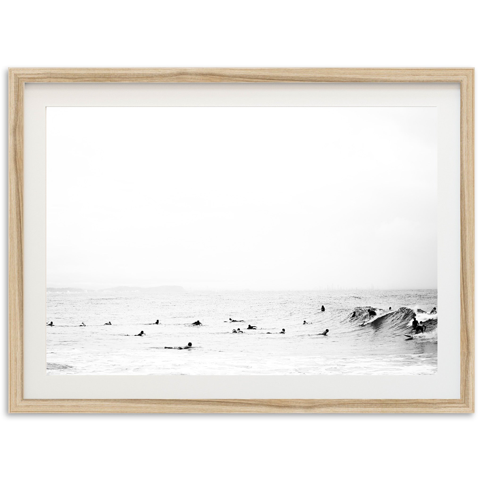 a black and white photo of surfers in the ocean